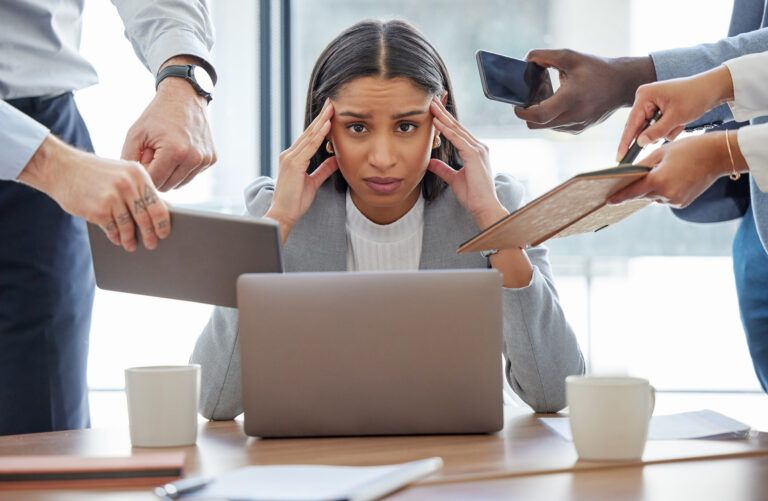 This is too much for me. Shot of a young businesswoman feeling stressed out in a demanding office environment at work